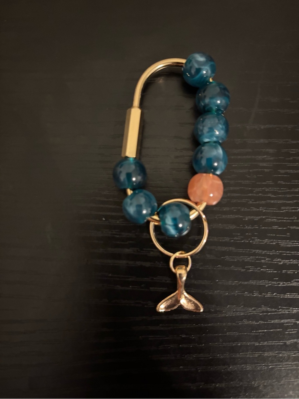 Gold Charm Bracelet with Teal Beads and Peach Accent